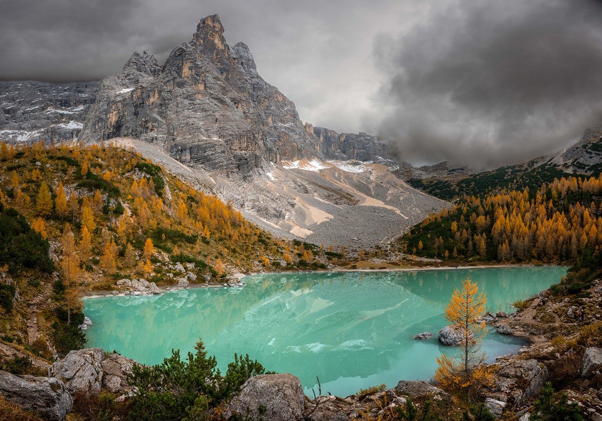 Autumn landscape in the Dolomites with colorful forests and mountain peaks
