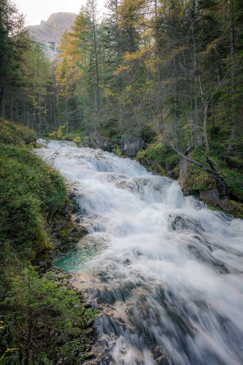 Waterval tussen groene vegetatie in de Fanes vallei