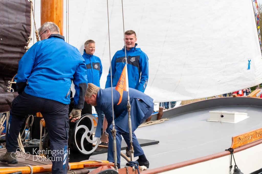 Crew members working on a traditional sailboat at Keningsdei Dokkum.