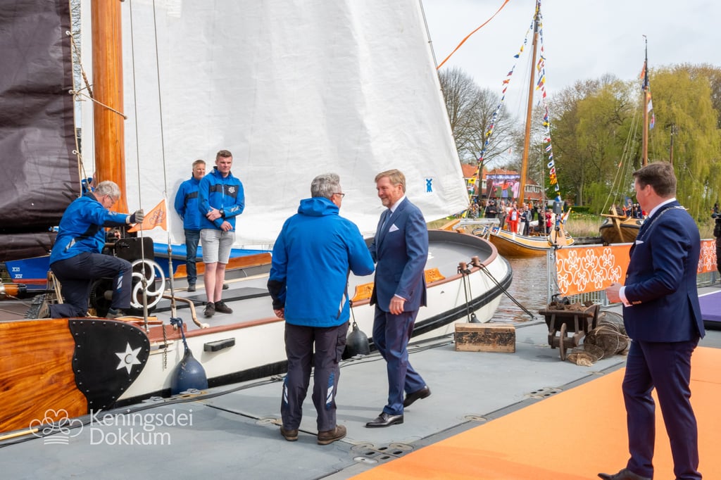 King's Day celebration at Dokkum harbor with traditional sailing boats.